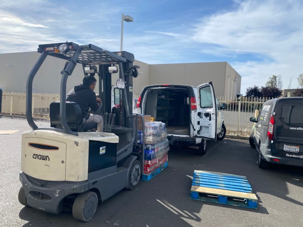 Forklift loading a delivery van at the Al Eryani Wholesale warehouse