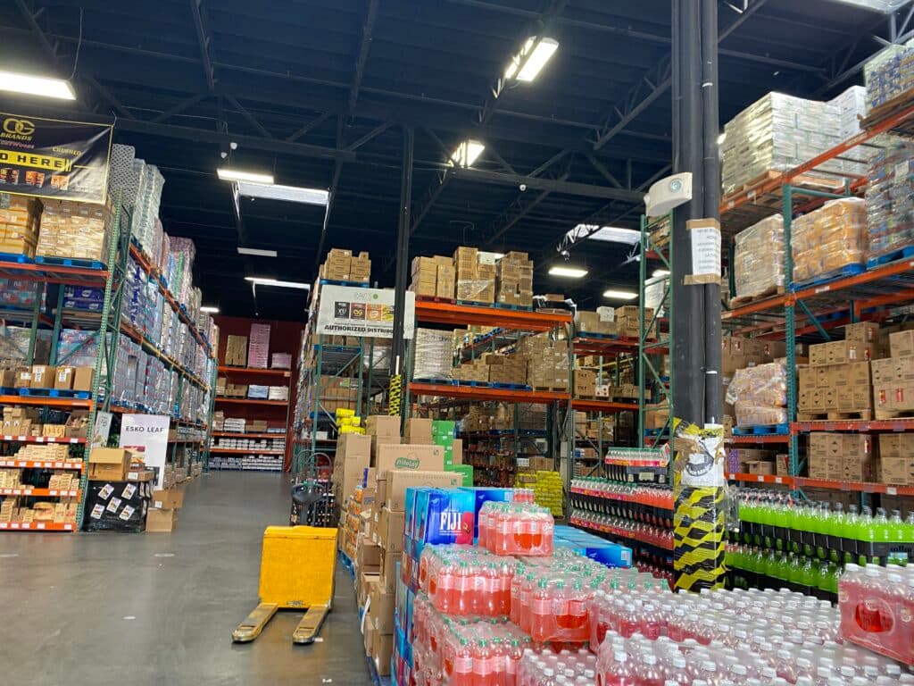 Wide warehouse floor with pallets of bottled water and beverages
