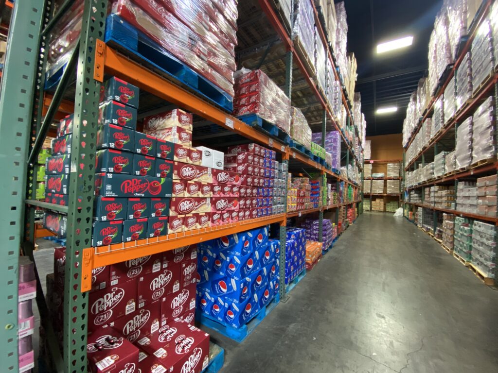 Dr Pepper and Pepsi soda cases on warehouse shelves